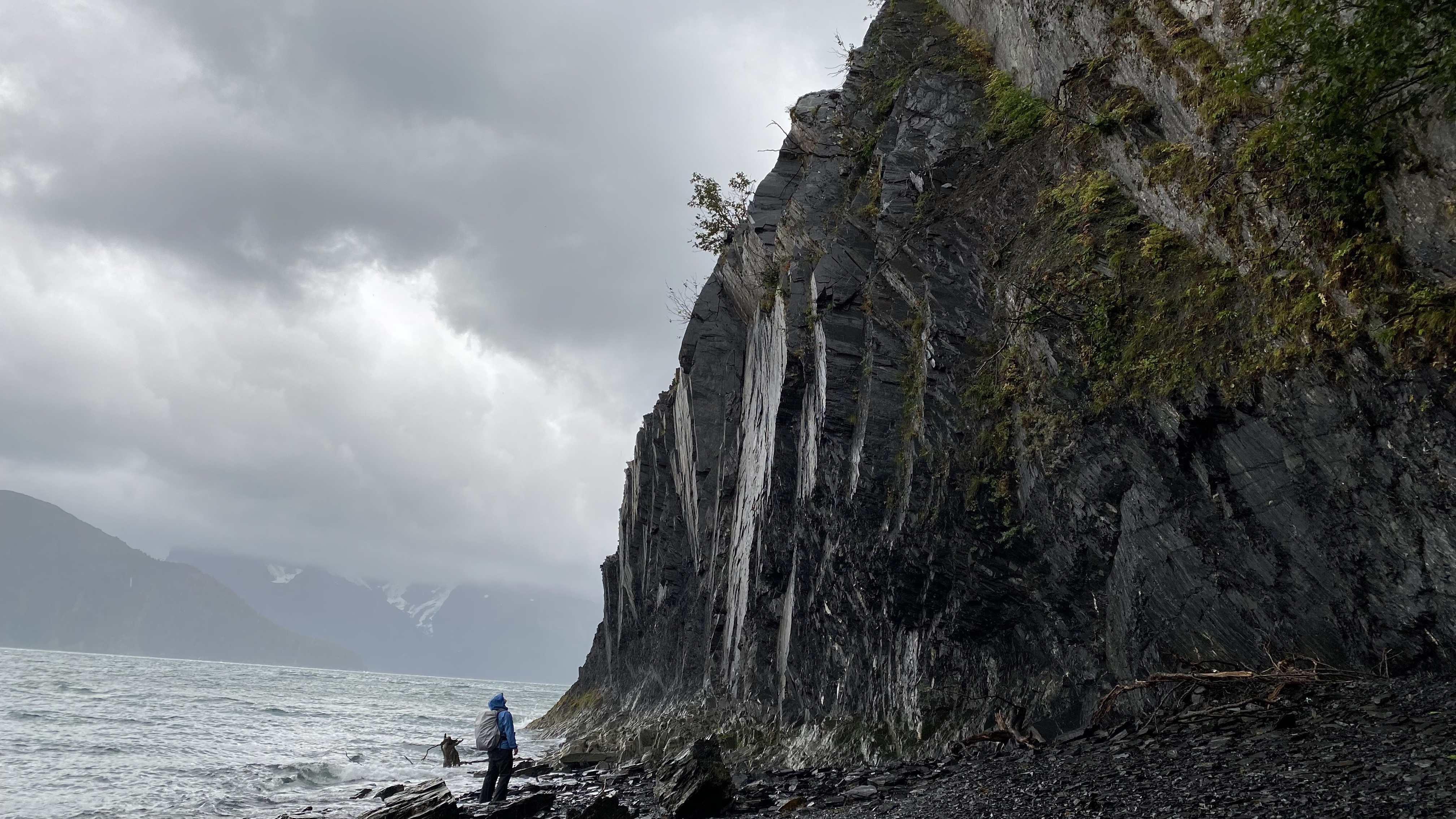Towering cliffs of Caines Head rise sharply from Resurrection Bay at North Beach. September 2021