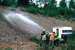 A small “research class” hydroseeder being used by Plant Materials Center staff in a Southcentral gravel pit plot.