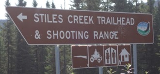 photo of the milepost sign for the Stiles Creek Trailead and Shooting Range