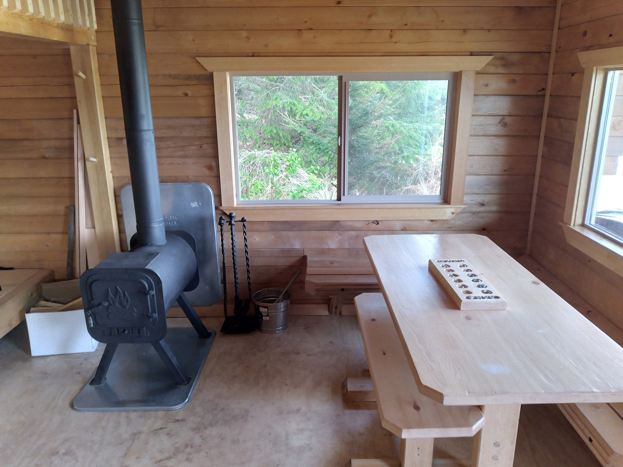 Clover Beach Cabin Interior Stove and table