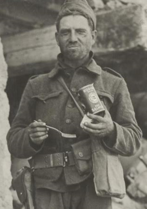 A WWI soldier eating canned salmon.