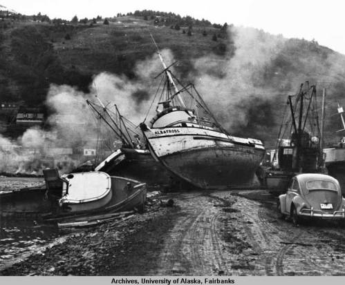 The Albatross fishing boat is beached following the earthquake and tsunami on March 29, 1964, with other wreckage, and a Volkswagen Beetle surrounding it. Image courtesy of University of Alaska Fair-banks, Alaska and Polar Regions Collections, Alaska Earthquake Archives Committee Collection, UAF-1972-153-218.