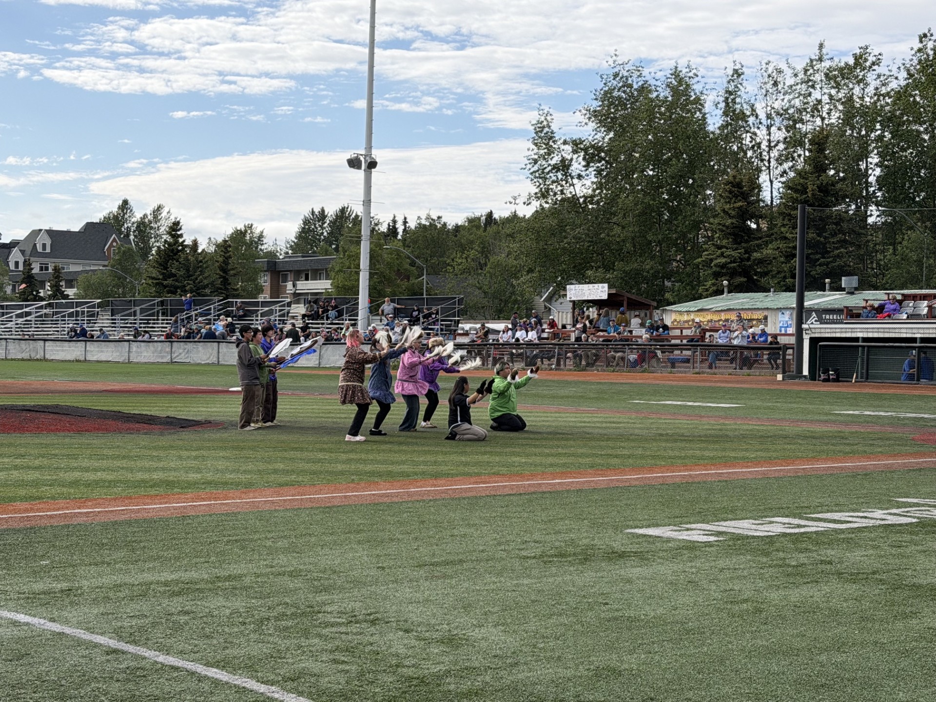 Alaska Native Heritage Dancers dancing on baseball field