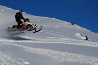 Snowmobiling over mountain